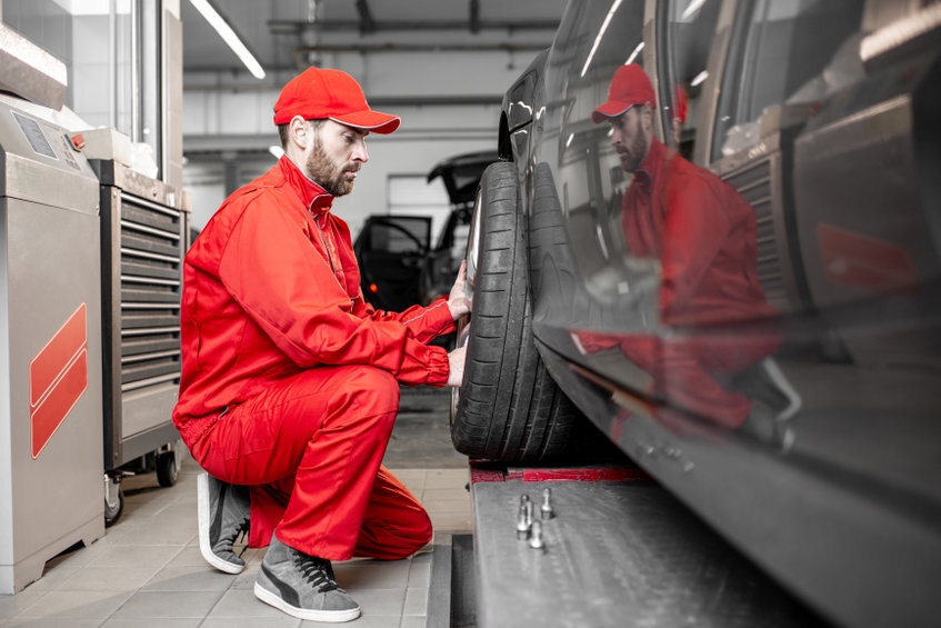 Workers changing wheels at the car service