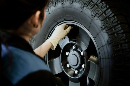 auto technician performing a tire rotation service